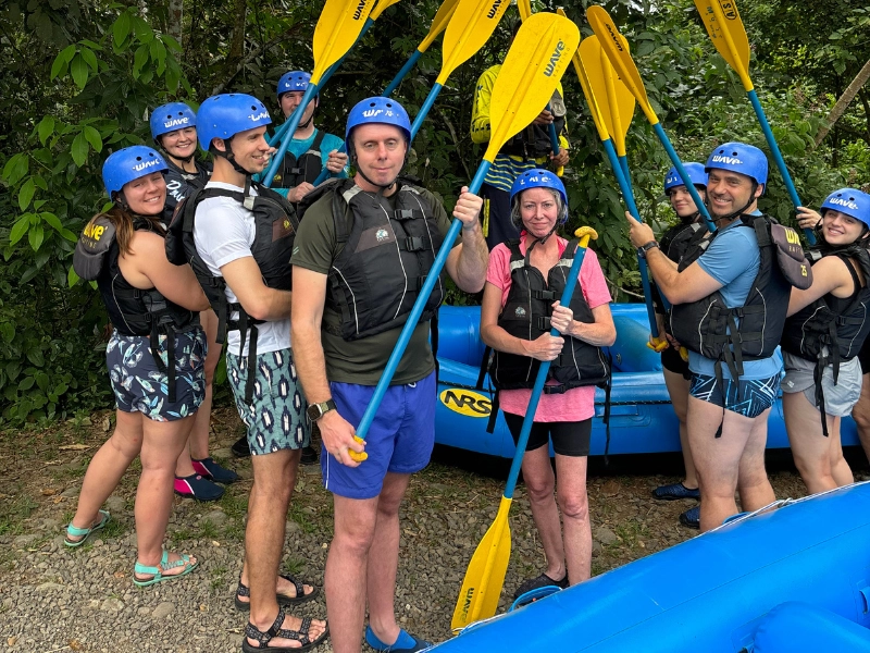 A family group posing with paddles after an Arenal rafting experience.